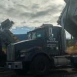 TNT Kelowna dump trucks providing hauling and trucking services at a construction site