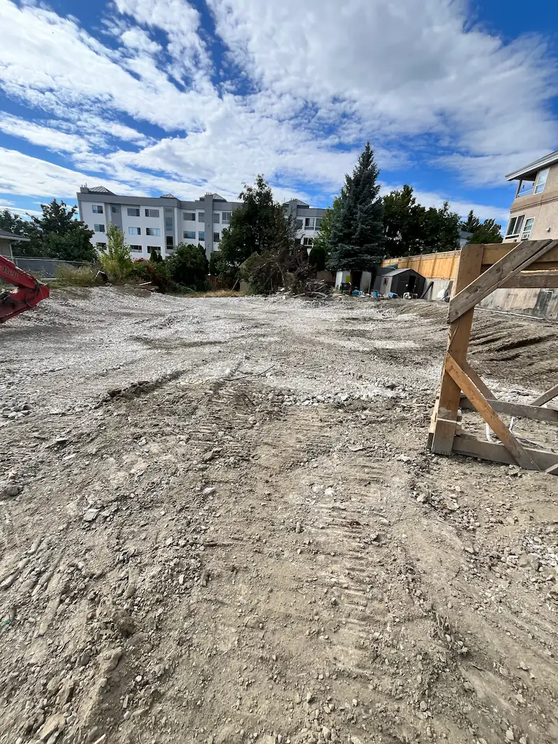 Freshly graded building pad with compacted subgrade and clean site boundaries in Kelowna, BC
