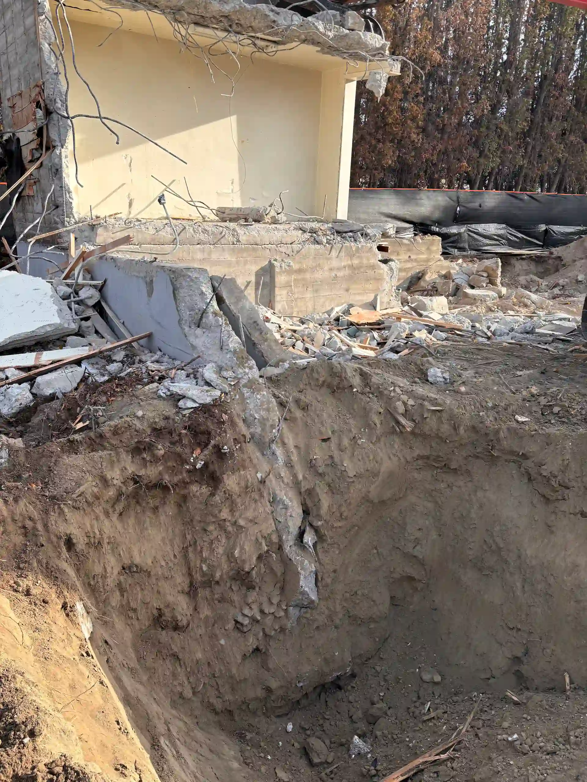 Residential foundation excavation pit next to a house in Kelowna, BC.