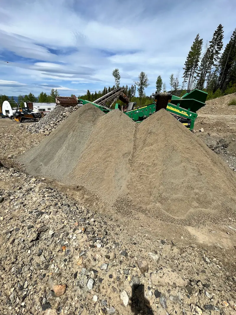 Aggregate stockpiles beside a mobile screening plant for materials supply and spoils management in Kelowna, BC