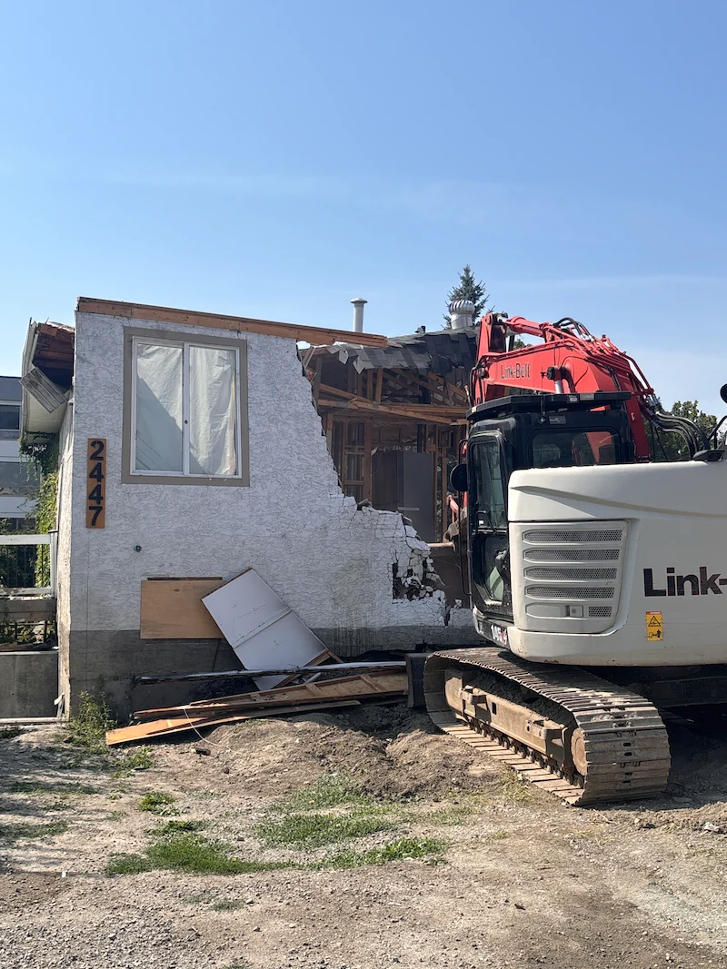 Excavator removing a single-family house during residential demolition in Kelowna, BC