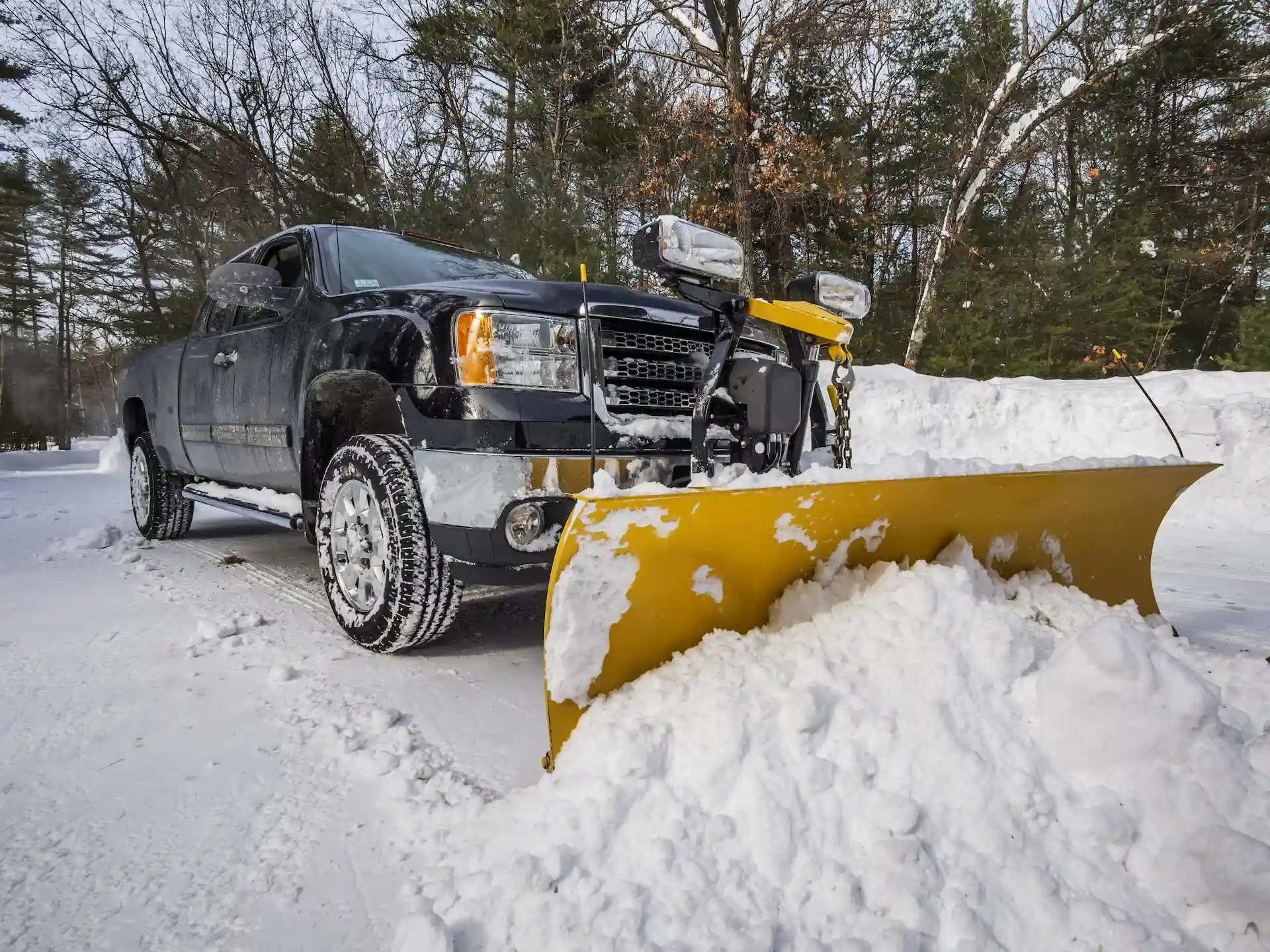 Kelowna snow removal truck plowing a residential driveway