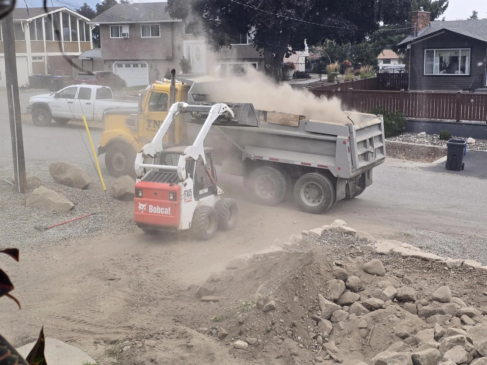 TNT Kelowna mini loader and dump truck used for excavation work